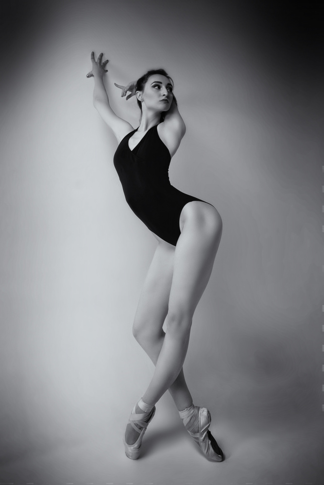 ballerina in a bodysuit improvises classical and modern choreography in a photo studio von Alexandr