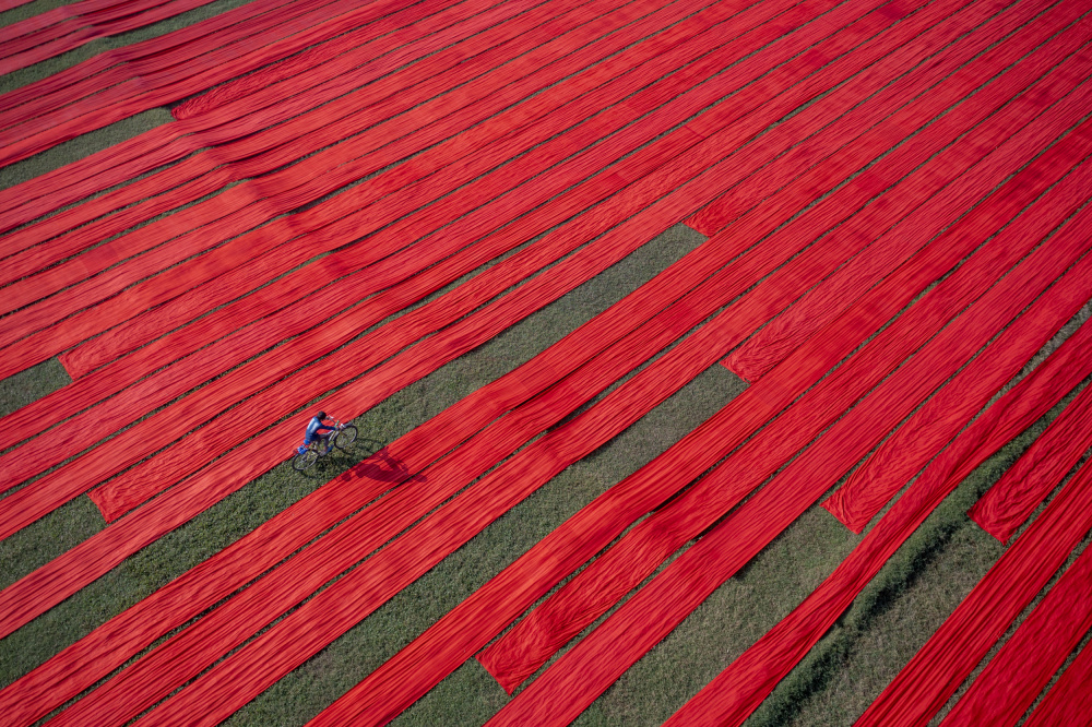 Bicyclist on the red fabrics von Azim Khan Ronnie