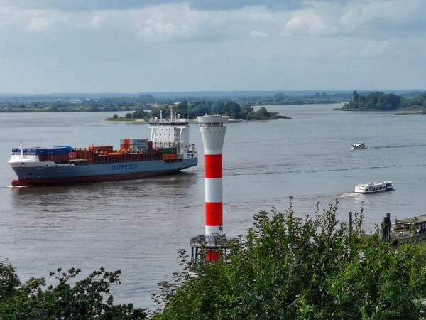 An der Elbe - Leuchtturm vor Containerschiff an der Elbe von Doris Beckmann