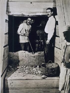 Howard Carter (1873-1939) and a colleague standing beside a partially demolished wall to one of the 