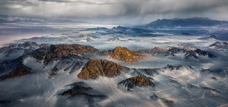 Black mountain is surging with wind and clouds